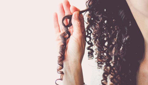Hairstylists Explain *Exactly* How To Use Olaplex on Curly Hair To Reduce Damage and Breakage