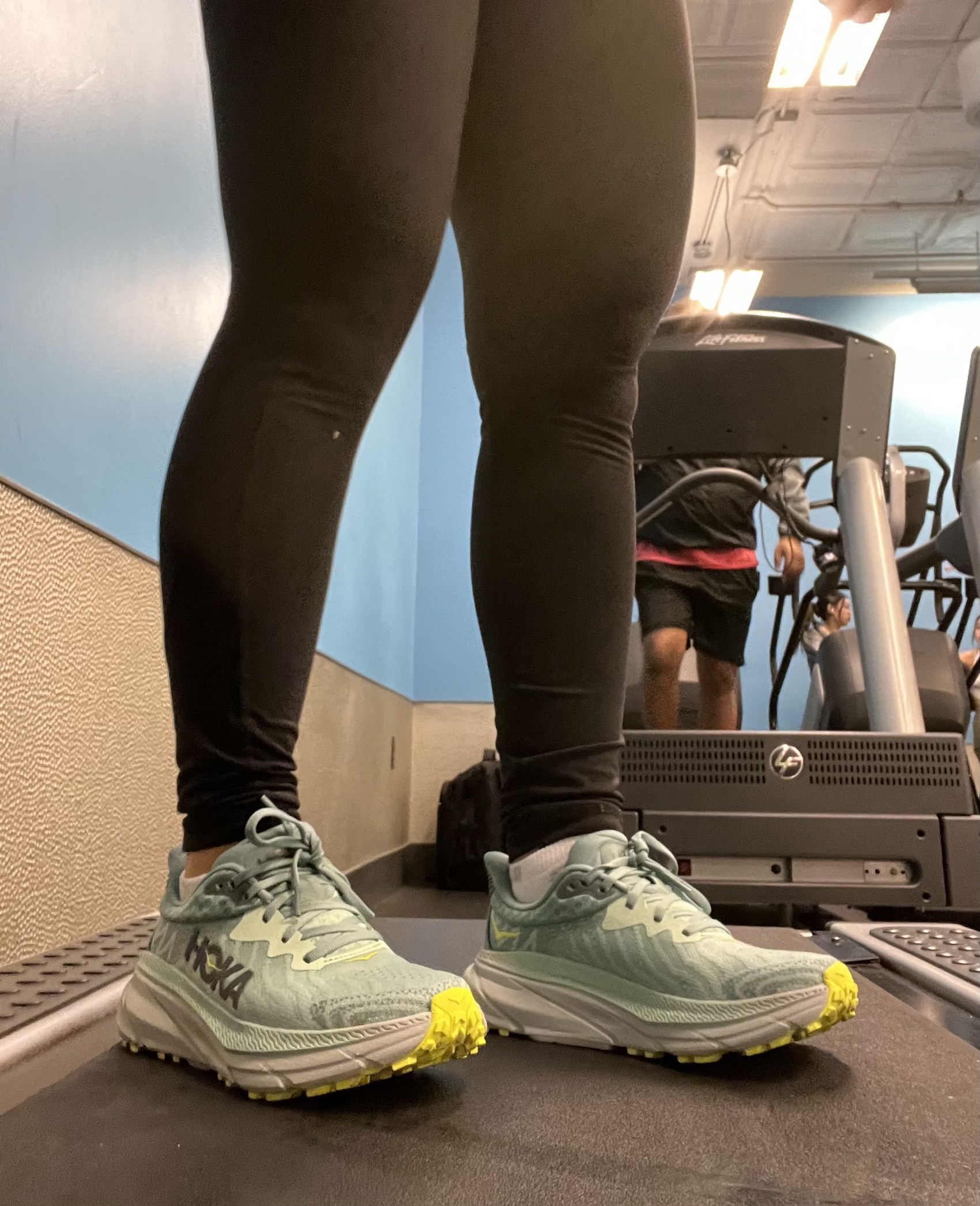person wearing hoka sneakers on treadmill