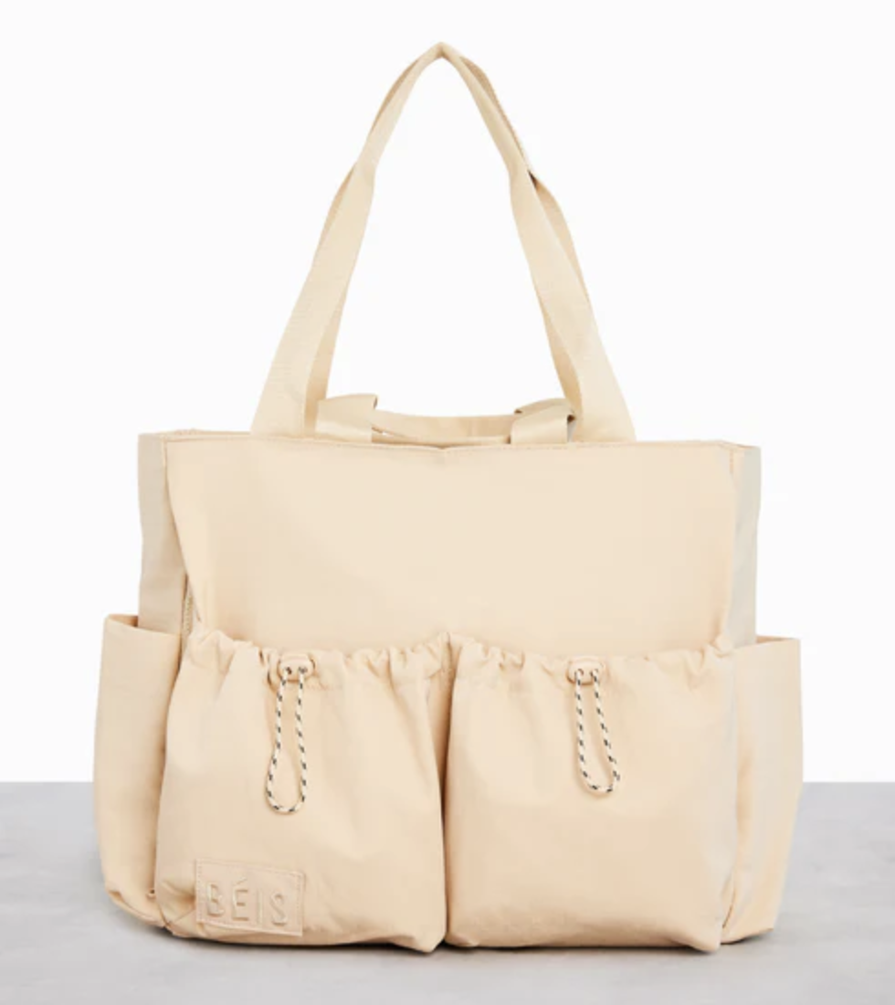 A tan bag with large pockets and handles.