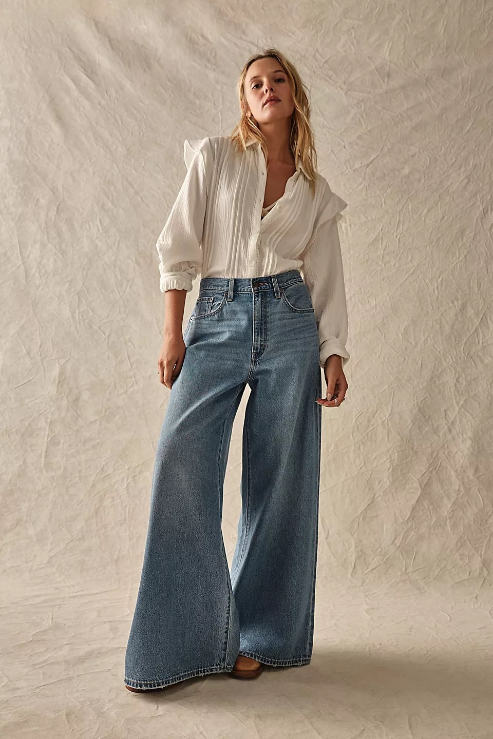 model wearing levis xl flood wide leg jeans and a white flowy top