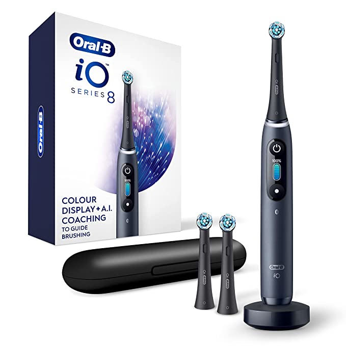 oral-b io series 8 toothbrush with the replacement heads, travel case, charging dock, and the box