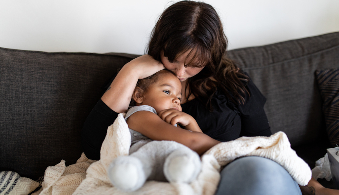 mother comforting kid wondering how to prevent cold and flu