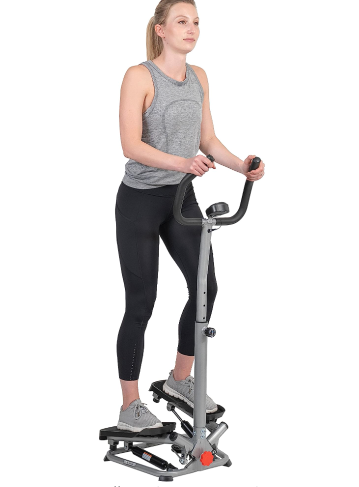 a woman using the sunny health and fitness twisting stair stepper for at-home workouts
