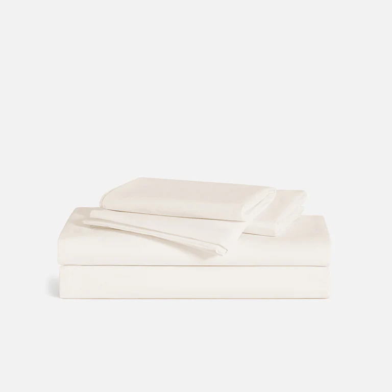 a stack of white brooklinen sateen core sheets, one of the best sheets for eczema