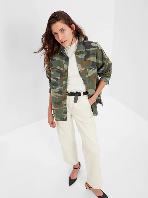 model wearing gap camo shirt jacket over a white t-shirt and white pants