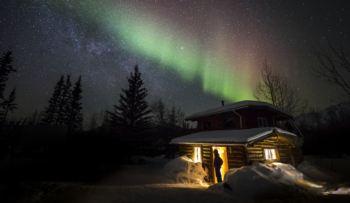winter cabin under the northern lights