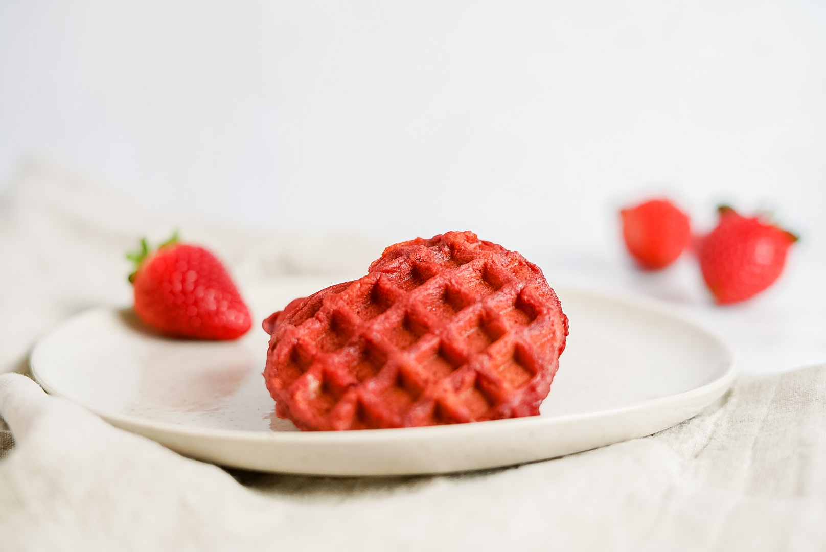 dash heart shaped waffles maker on a plate
