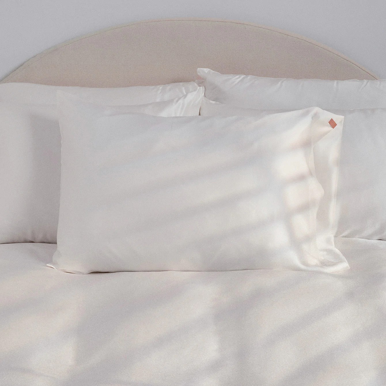 lunya washable silk pillowcase on a bed