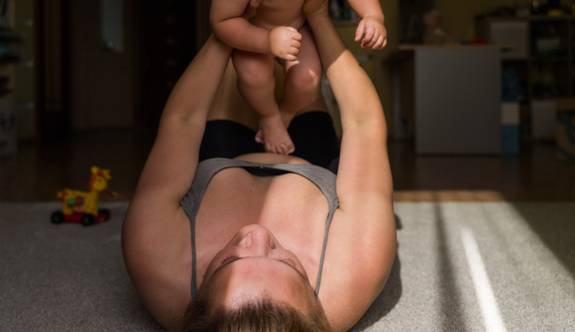 woman playing with baby with postpartum hypertension
