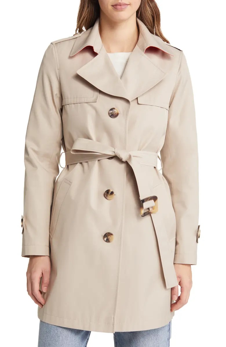 sam edelman trench coat in beige on a model wearing a white shirt and jeans
