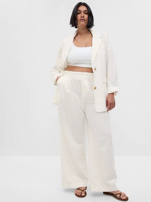 gap white linen blazer on a model wearing a white bra top and matching white pants.