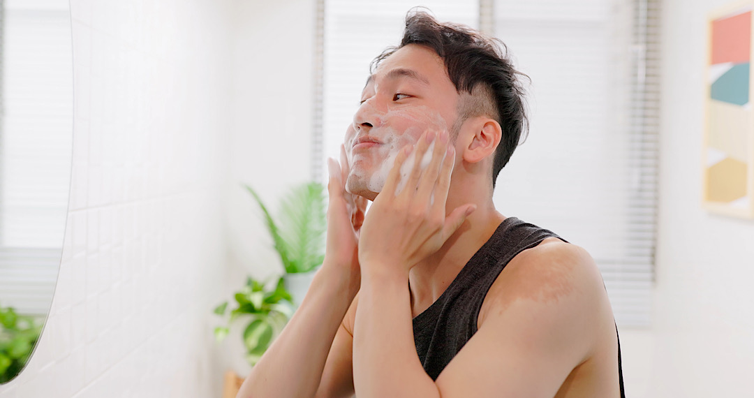 Asian man washing face.