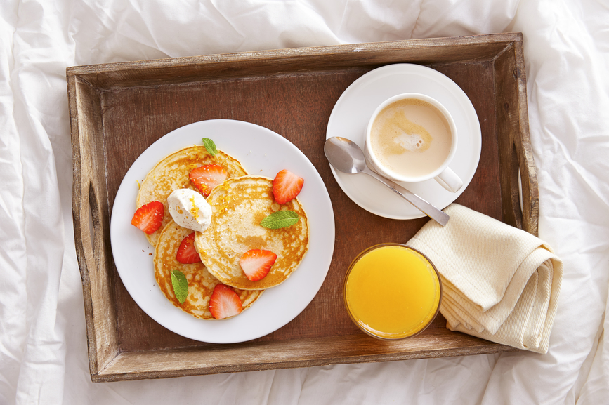 orange juice and coffee breakfast in bed