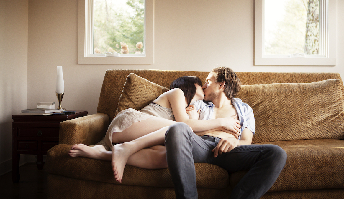 couple kissing on a couch
