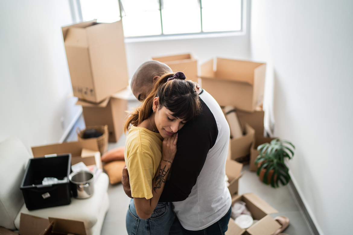 Couple embracing leaving home