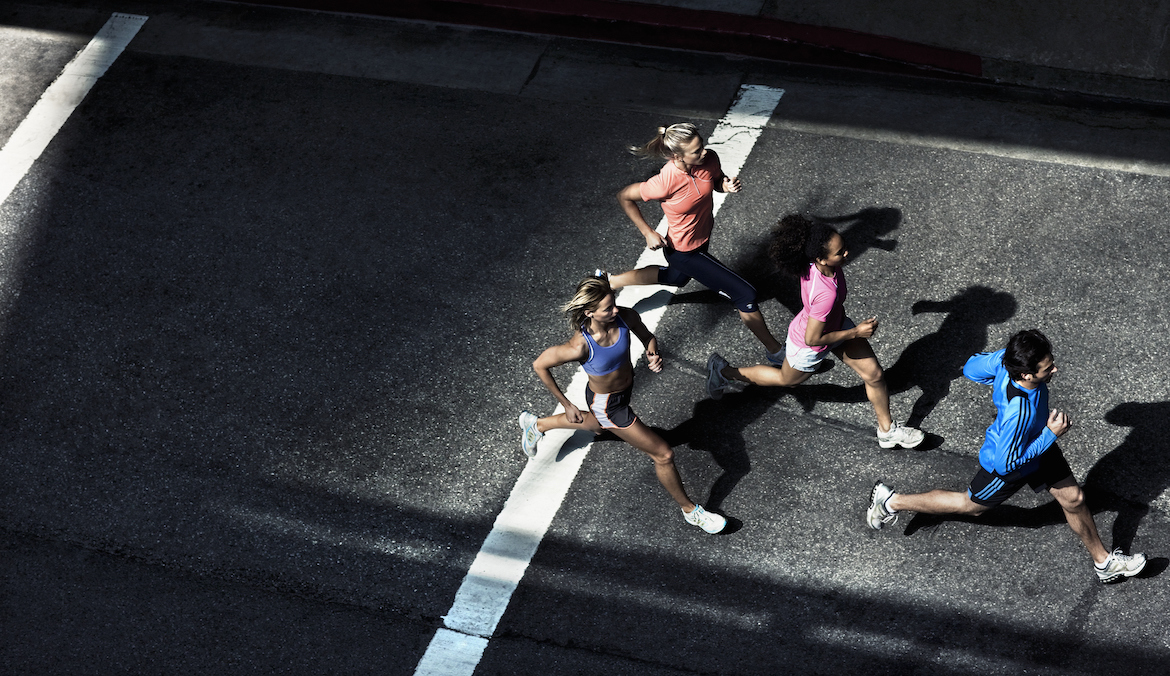 Overhead view of runners on urban street