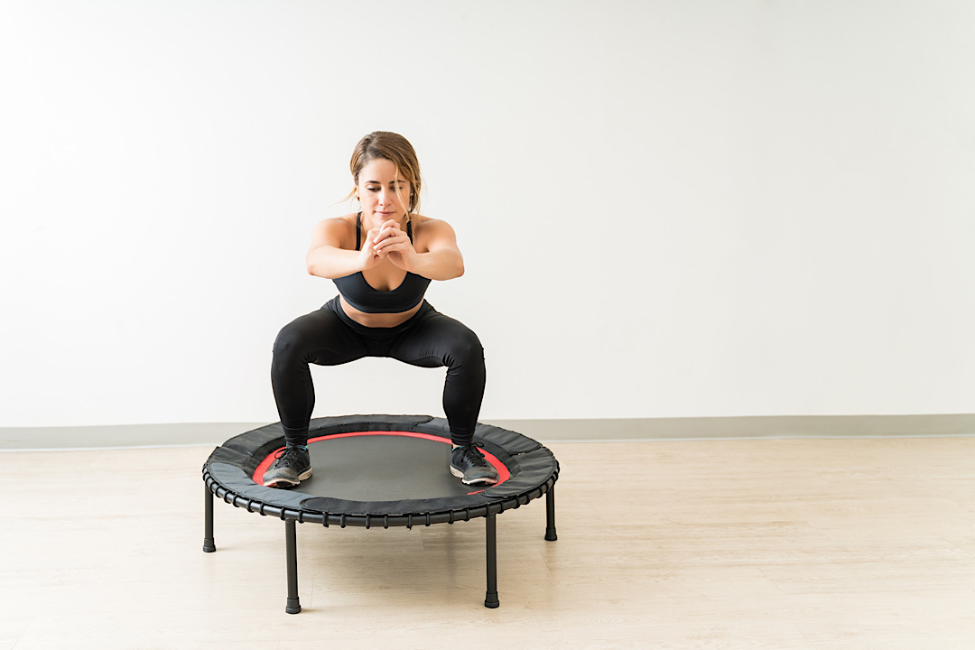 Woman working out on mini trampoline.