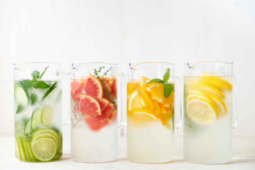 Four glasses of sparkling water with artificial sweeteners and fruit.