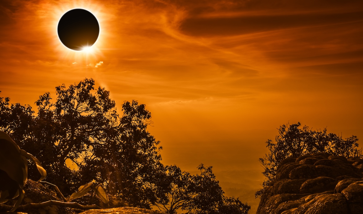 Total solar eclipse glowing on sky and cloudy above view point on the top of mountain, serenity nature in forest. Abstract fantastic background.