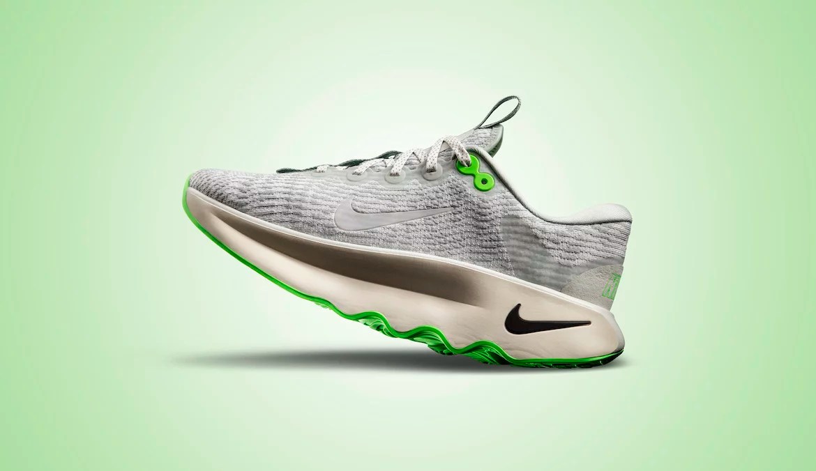 A gray sneaker with a neon green bottom, white sole, and a black Nike swoosh.