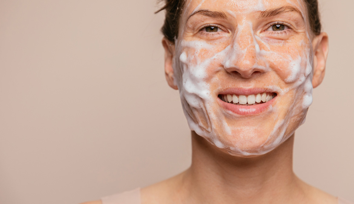 A woman with emulsified cleanser on her face.