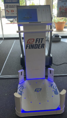 A white platform with a tall back with "Fit Finder" written on it.