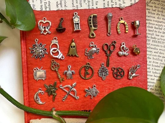 Charms laid out on a red mat to be used for charm casting. 