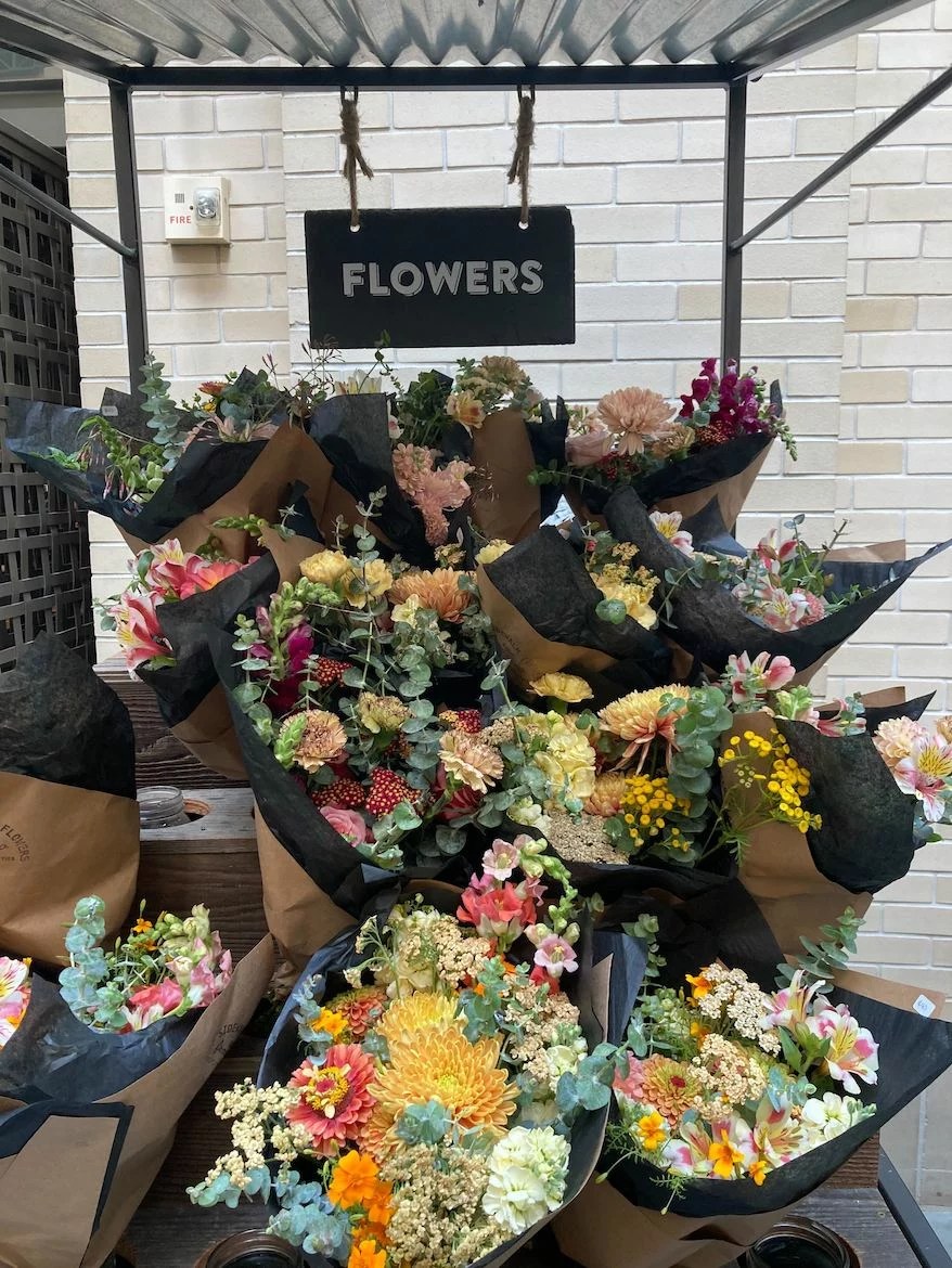 A stall of flowers at a farmers market.