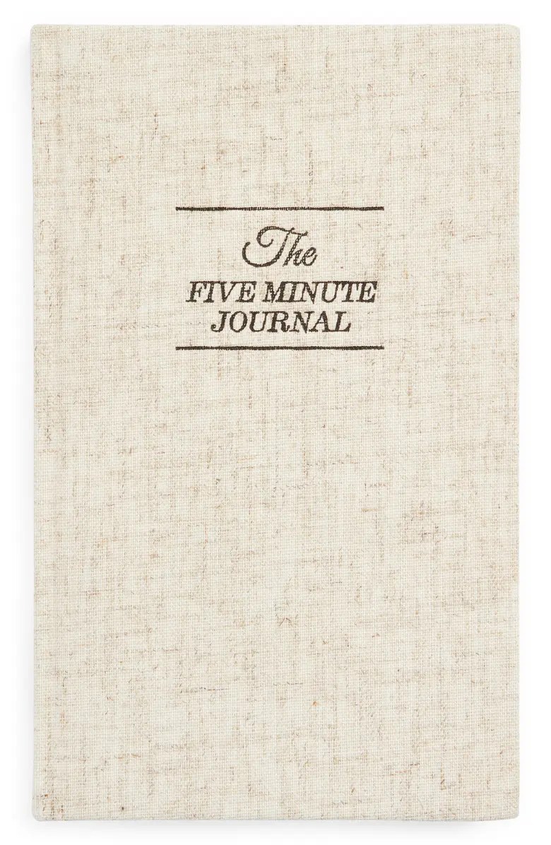 a cream colored five minute journal