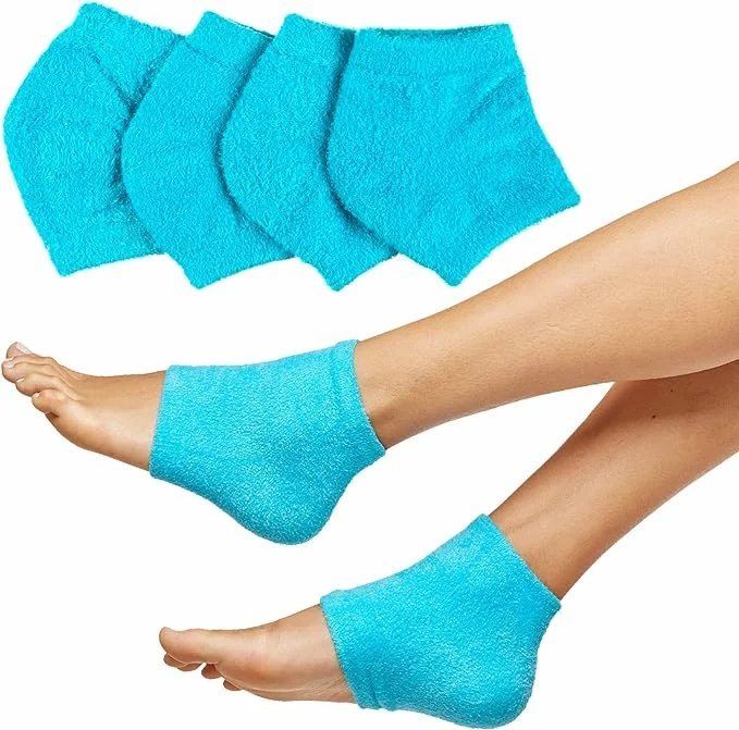 A woman's lower legs and feet, shown wearing blue socks around the heels.