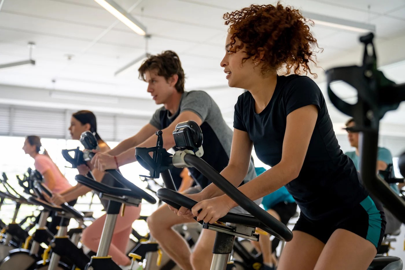 People in a spin class. Here's why group fitness classes can feel defeating