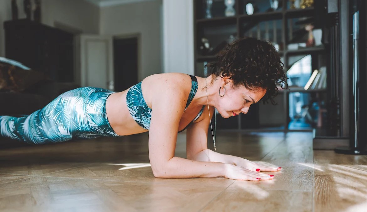 Woman doing a plank as an exercise to prevent injury