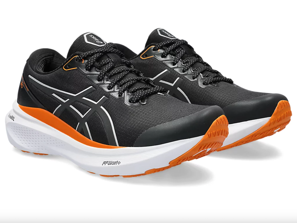 A black running shoe with white and orange accents.