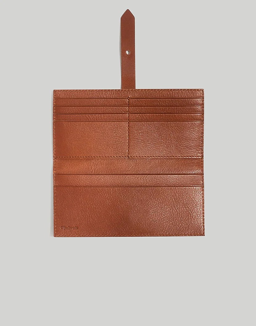 a brown leather post wallet from madewell, one of the best slim wallets