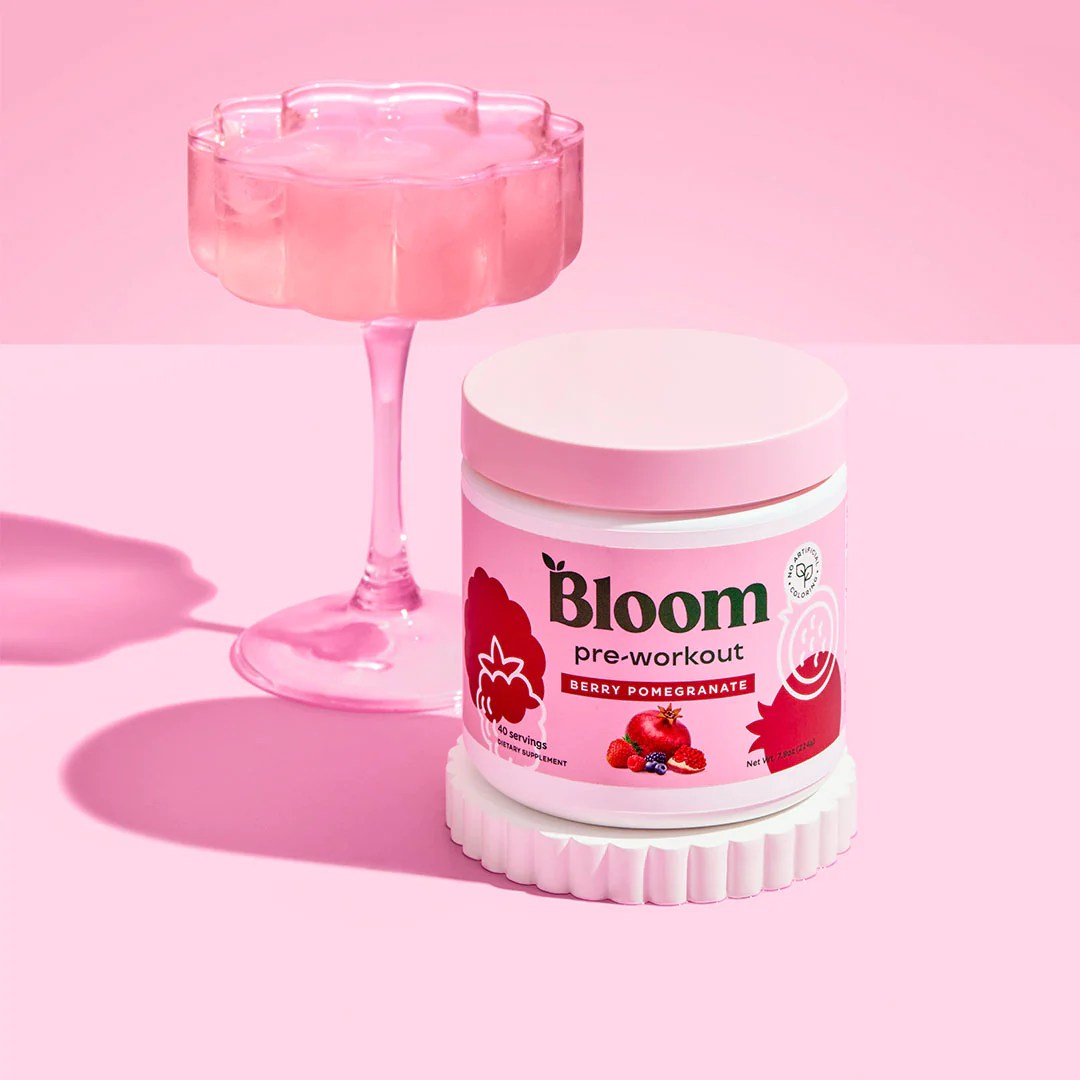 a container of bloom pre workout on a pink background