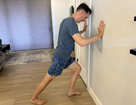 Physical therapist demonstrating active gastrocnemius stretch