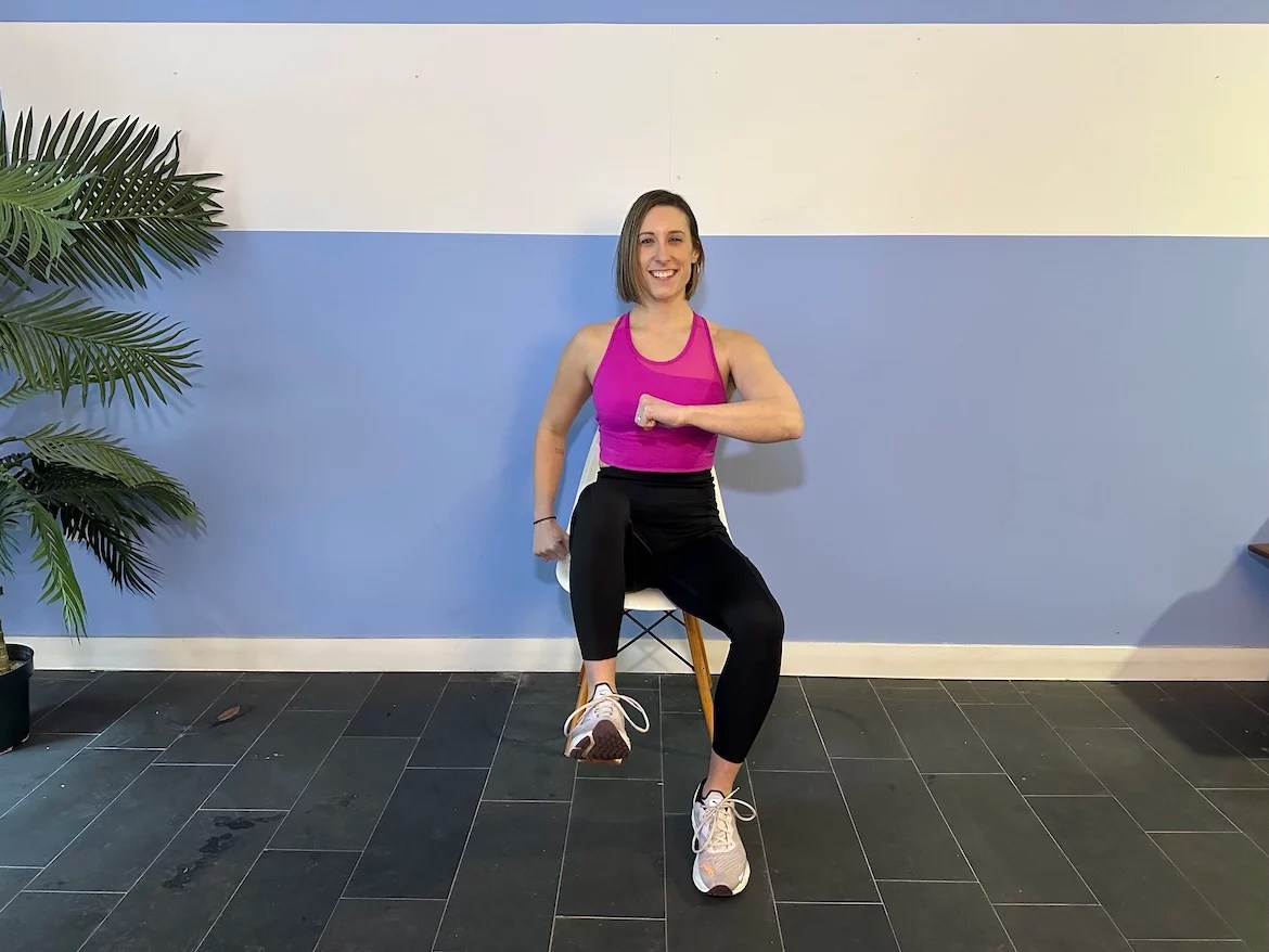 Personal trainer demonstrating seated march exercise