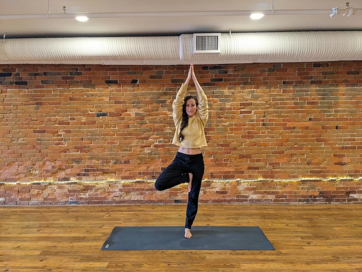 Yoga teacher demonstrating tree pose progression