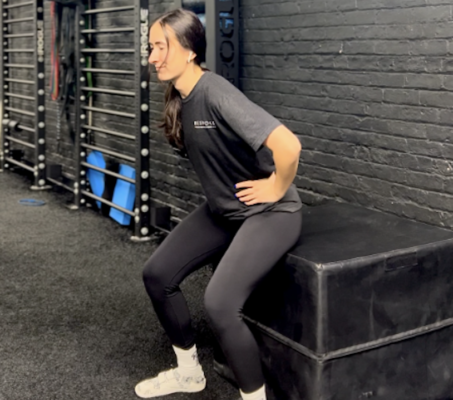 Physical therapist demonstrating box squat