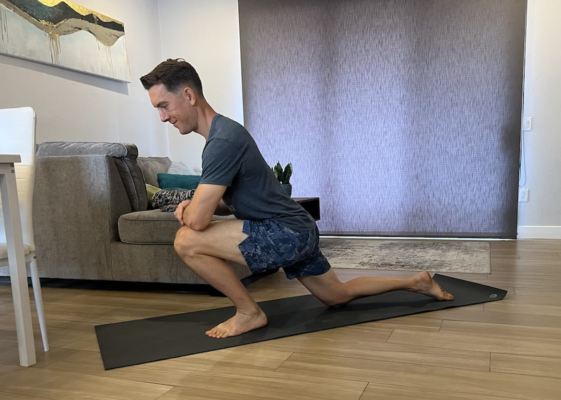 Physical therapist demonstrating half-kneeling calf stretch