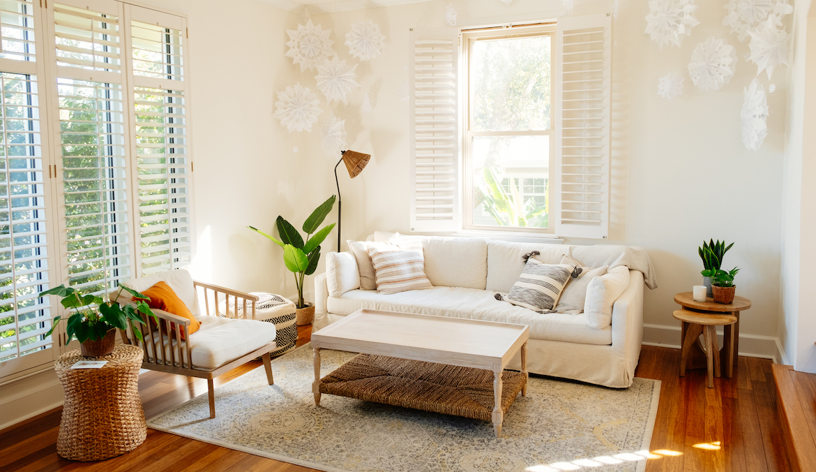 A sunlit living room with Nancy Meyers interior design-inspired décor