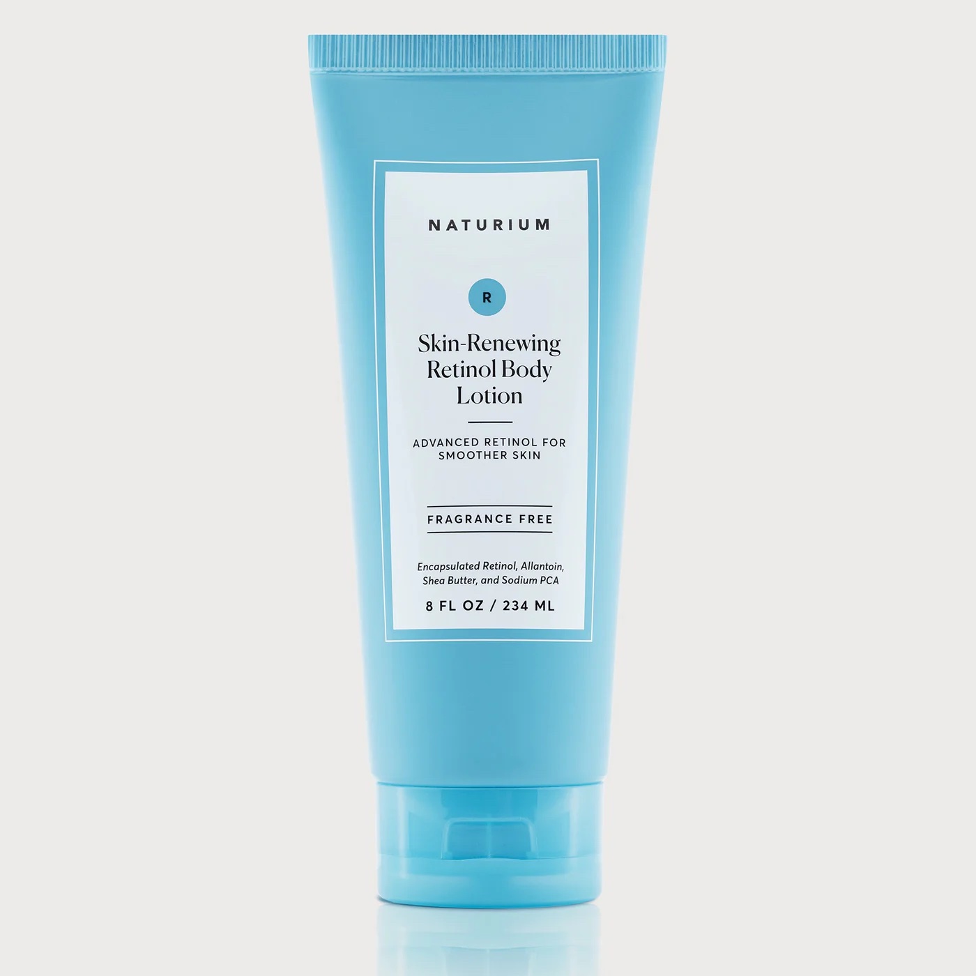 naturium retinol body lotion in a blue tube shown on a white background