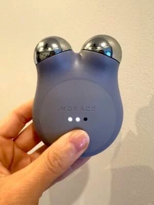 a purple nuface mini+ facial toning device