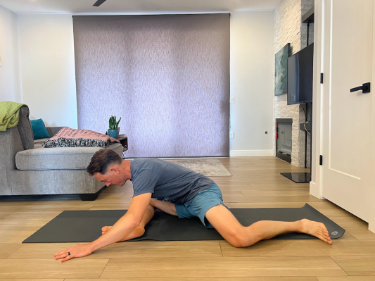 Physical therapist demonstrating 90-90 active stretch