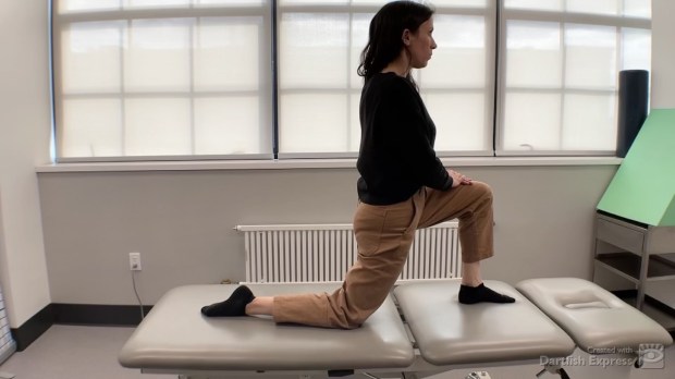 Physical therapist demonstrating kneeling half-lunge
