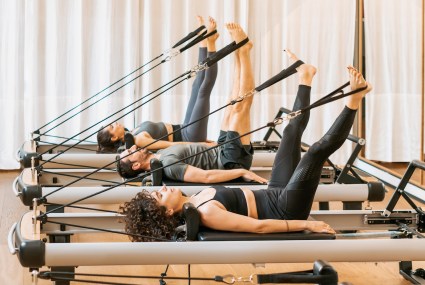 Debating Between Reformer and Mat Pilates? Here’s How To Tell Which Is Right for You