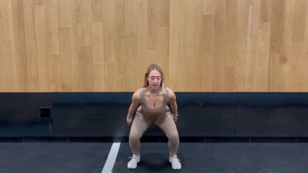 Personal trainer demonstrating squat jump