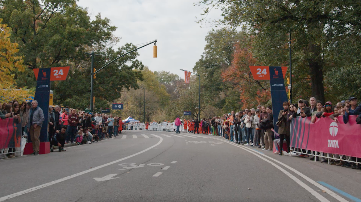 A road through central park flanked by race observers.