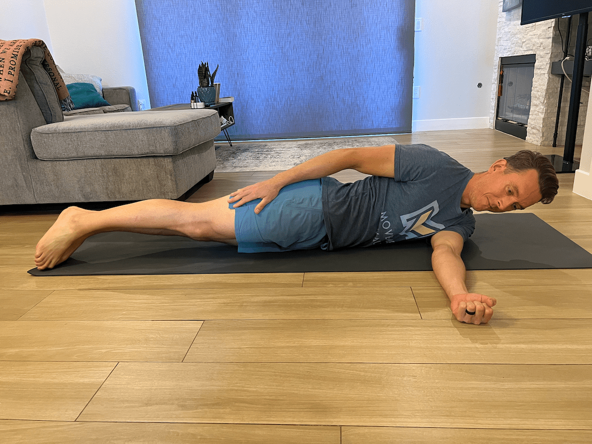 male physical therapist demonstrates how to do cross-chest eccentrics for rotator cuff strength