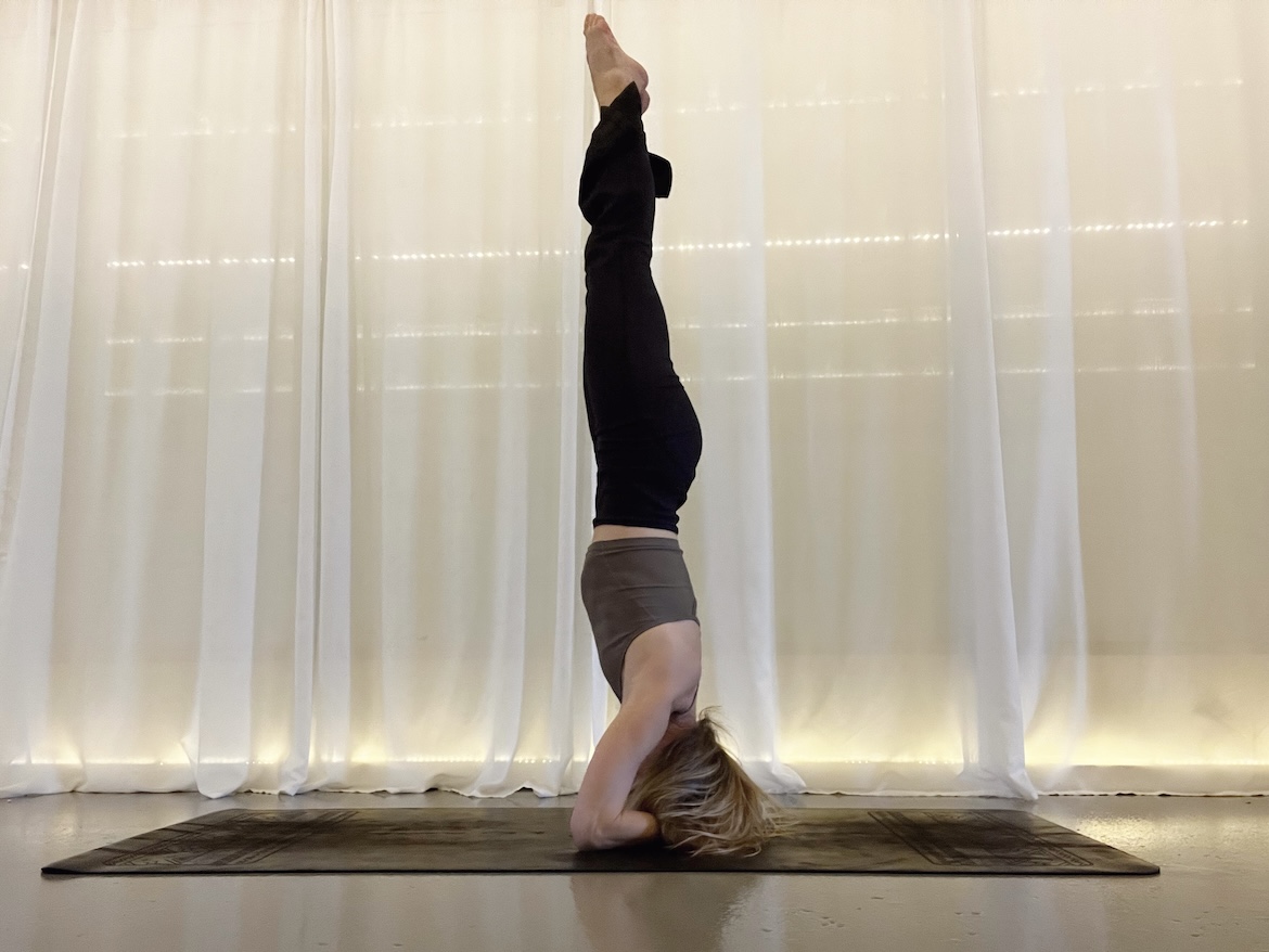 Yoga teacher demonstrating headstand